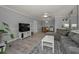 Open-concept living room with dining area, modern decor, and plenty of space at 1182 Pine Ridge W Cir # B1, Tarpon Springs, FL 34688