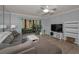 Cozy living room with access to the patio, ceiling fan, and modern furnishings at 1182 Pine Ridge W Cir # B1, Tarpon Springs, FL 34688