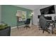 Home office featuring a modern desk, comfortable chairs, and ample workspace at 1182 Pine Ridge W Cir # B1, Tarpon Springs, FL 34688