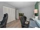 Home office featuring a modern desk, comfortable chairs, and ample workspace at 1182 Pine Ridge W Cir # B1, Tarpon Springs, FL 34688