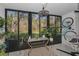 Screened patio with potted plants, view of backyard greenery, and outside storage at 1182 Pine Ridge W Cir # B1, Tarpon Springs, FL 34688