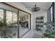 View from sunroom to living room through sliding glass doors at 1182 Pine Ridge W Cir # B1, Tarpon Springs, FL 34688