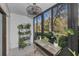Enclosed patio with shelving for plants and a view of lush greenery at 1182 Pine Ridge W Cir # B1, Tarpon Springs, FL 34688
