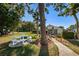 Community pool area with picnic table, palm trees and well-maintained landscaping on a sunny day at 1182 Pine Ridge W Cir # B1, Tarpon Springs, FL 34688
