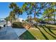Community pool area with palm trees, benches and well-maintained landscaping on a sunny day at 1182 Pine Ridge W Cir # B1, Tarpon Springs, FL 34688