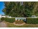Pine Ridge Village One entrance sign surrounded by manicured landscaping and greenery at 1182 Pine Ridge W Cir # B1, Tarpon Springs, FL 34688