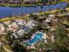 This is an aerial view of the community pool with a playground and walking paths around the community at 11965 Cinnamon Fern Dr, Riverview, FL 33579