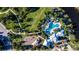 This aerial view showcases a community pool and playground set amongst trees and manicured landscaping at 11965 Cinnamon Fern Dr, Riverview, FL 33579