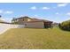 Expansive backyard with lush lawn and a white fence at 11965 Cinnamon Fern Dr, Riverview, FL 33579