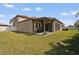 Spacious backyard featuring a lush lawn, pergola, screened lanai, and privacy fence at 11965 Cinnamon Fern Dr, Riverview, FL 33579