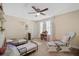 Comfortable bedroom with 2 beds, a chair and ottoman perfect for a Gathering with small children at 11965 Cinnamon Fern Dr, Riverview, FL 33579