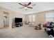 Large bonus room with carpet, ceiling fan, and an abundance of natural light from the windows at 11965 Cinnamon Fern Dr, Riverview, FL 33579