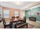 Dining room with a dark wood dining table, bright lighting, and decorative rug at 11965 Cinnamon Fern Dr, Riverview, FL 33579