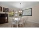 Bright dining room with a white dining set and a decorative world map on the wall at 11965 Cinnamon Fern Dr, Riverview, FL 33579