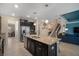 Spacious kitchen with a large center island, stainless steel appliances, and open floor plan at 11965 Cinnamon Fern Dr, Riverview, FL 33579