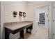 Convenient laundry room with granite countertop folding area and access to the closet at 11965 Cinnamon Fern Dr, Riverview, FL 33579