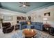 Spacious living room featuring a large sectional sofa, ceiling fan, and open floor plan to the kitchen at 11965 Cinnamon Fern Dr, Riverview, FL 33579