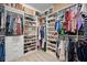Spacious walk-in closet with custom shelving and ample storage space for clothing and accessories at 11965 Cinnamon Fern Dr, Riverview, FL 33579