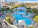 Aerial view of the community pools, landscaping, and surrounding city from this high rise condominium complex at 1209 E Cumberland Ave # 1703, Tampa, FL 33602