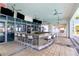Outdoor bar area featuring a granite countertop, stainless steel fixtures, ceiling fans, and tile flooring at 1209 E Cumberland Ave # 1703, Tampa, FL 33602