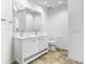 This bathroom offers a double vanity with sleek fixtures and a large mirror, plus a toilet in a clean, bright space at 1209 E Cumberland Ave # 1703, Tampa, FL 33602