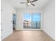 Bedroom with a door to a balcony offering city views; features light wood floors and neutral walls at 1209 E Cumberland Ave # 1703, Tampa, FL 33602