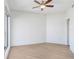 A simple bedroom with light-colored wood floors and a ceiling fan, offering a bright and airy feel at 1209 E Cumberland Ave # 1703, Tampa, FL 33602