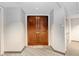 A condo entryway with double wood doors and a mat that says 'Be Our Guest' at 1209 E Cumberland Ave # 1703, Tampa, FL 33602