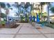 Outdoor patio area with grill station, umbrella-shaded tables, and lush tropical landscaping for a relaxing atmosphere at 1209 E Cumberland Ave # 1703, Tampa, FL 33602