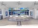 Outdoor pool bar featuring multiple TVs, modern seating, and a relaxed atmosphere near the community pool at 1209 E Cumberland Ave # 1703, Tampa, FL 33602