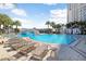 Resort-style pool with a bridge, waterfall feature, and lounge chairs overlooking the water in a serene setting at 1209 E Cumberland Ave # 1703, Tampa, FL 33602