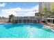 Stunning resort-style pool with a rock waterfall feature and lush landscaping creating a tranquil oasis at 1209 E Cumberland Ave # 1703, Tampa, FL 33602