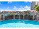 Picturesque rock waterfall cascading into a crystal-clear pool, enhancing the building's resort-style amenities at 1209 E Cumberland Ave # 1703, Tampa, FL 33602