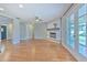 Bright living room with a charming fireplace, ceiling fan, and double doors leading to the backyard at 1209 Thomas Jacobs Pl, Brandon, FL 33510