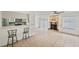 Open-concept living room with fireplace, tile floors, and bar seating area to kitchen for easy entertaining at 12405 Titus Ct, Tampa, FL 33612