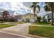 Charming two-story home with a well-manicured lawn, driveway, and neatly landscaped front yard at 126 82Nd N Ave, St Petersburg, FL 33702