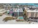 Aerial view showcases condos, beach access, pool and coastal beauty, for the best vacation at 12924 Gulf Blvd # 110, St Petersburg, FL 33708