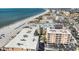 Aerial view captures the coastline, beachfront condos, and panoramic ocean views for tranquil living at 12924 Gulf Blvd # 110, St Petersburg, FL 33708