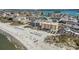 Aerial view of beachfront condos and pristine sands with clear blue skies and ocean views at 12924 Gulf Blvd # 110, St Petersburg, FL 33708