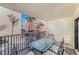 Outdoor balcony featuring a glass table, seating, and partial views of tropical landscaping at 12924 Gulf Blvd # 110, St Petersburg, FL 33708