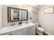 Bathroom with double sink vanity, tile floors, and decorative accents at 12924 Gulf Blvd # 110, St Petersburg, FL 33708