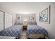 Comfortable bedroom with two beds, light walls and closet at 12924 Gulf Blvd # 110, St Petersburg, FL 33708