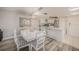 Dining area with white table set, stylish seating, chandelier, and flows into the adjacent kitchen at 12924 Gulf Blvd # 110, St Petersburg, FL 33708