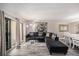 Relaxing living room features a large sectional couch, glass coffee table, and balcony access at 12924 Gulf Blvd # 110, St Petersburg, FL 33708