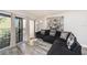 Living area with sliding doors to balcony, modern furniture, and decorative artwork at 12924 Gulf Blvd # 110, St Petersburg, FL 33708