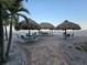 Inviting outdoor seating beneath the tiki huts, with views of the gulf coast beach at 12924 Gulf Blvd # 110, St Petersburg, FL 33708