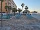 Enjoy the pool with beach views, palm trees, a tiki hut and lounge chairs for ultimate relaxation at 12924 Gulf Blvd # 110, St Petersburg, FL 33708