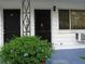 Charming home exterior with dual front doors, an air conditioner, and green bush at 1345 Drew St # 5, Clearwater, FL 33755