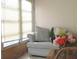 Cozy living room featuring a comfortable couch with pillows, a decorative flower arrangement, and natural light from the window at 1345 Drew St # 5, Clearwater, FL 33755