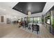 Open-concept living room boasts modern lighting, sleek furniture, and outdoor access at 15539 Stuart Cir, Port Charlotte, FL 33981